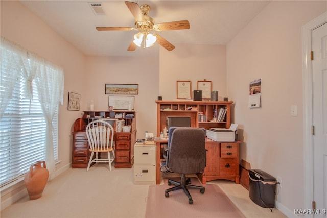 carpeted office space with ceiling fan