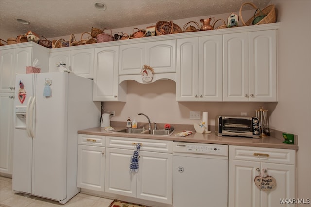 kitchen featuring white cabinetry, white appliances, a textured ceiling, light tile patterned floors, and sink