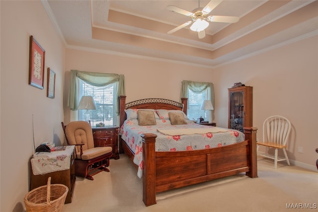 bedroom featuring ornamental molding, a raised ceiling, light carpet, and ceiling fan