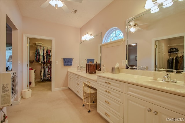 bathroom featuring a textured ceiling, vanity, and ceiling fan