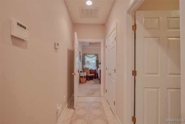 hall featuring light tile patterned floors