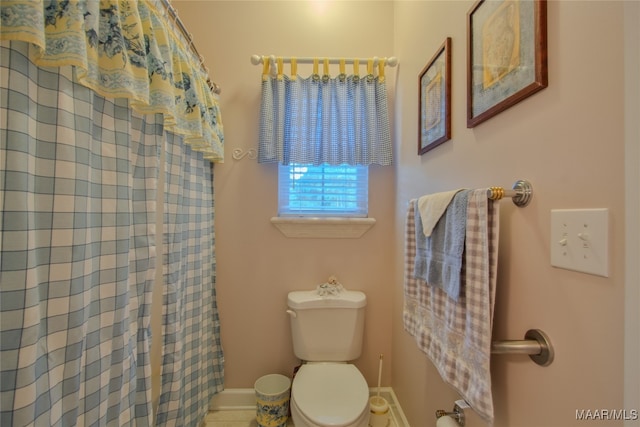 bathroom with toilet and walk in shower