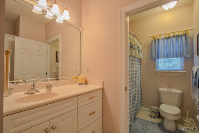 bathroom featuring vanity, toilet, and a textured ceiling