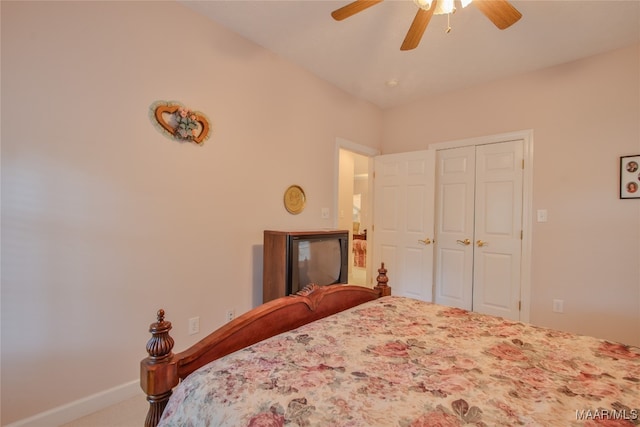 carpeted bedroom with ceiling fan and a closet