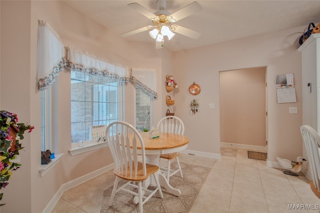 tiled dining space with ceiling fan