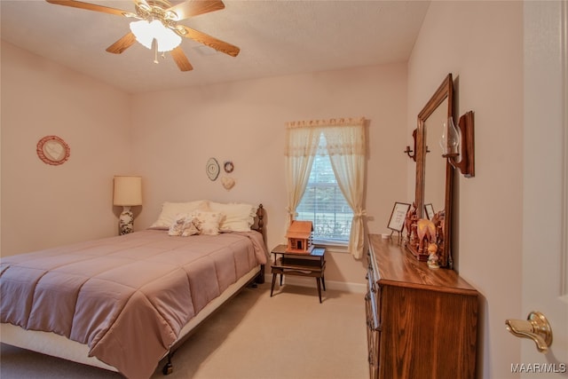 bedroom with ceiling fan and light carpet