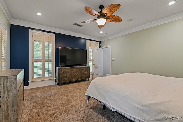 carpeted bedroom featuring ceiling fan and crown molding