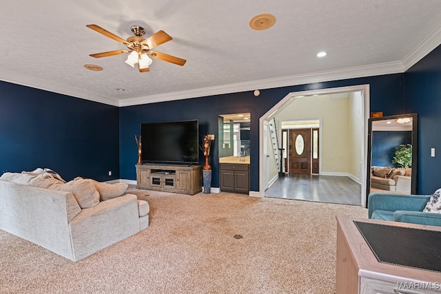 carpeted living room with ceiling fan, a textured ceiling, and crown molding