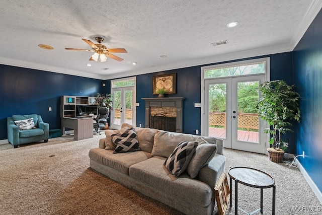 living room with a textured ceiling, a healthy amount of sunlight, ceiling fan, and french doors