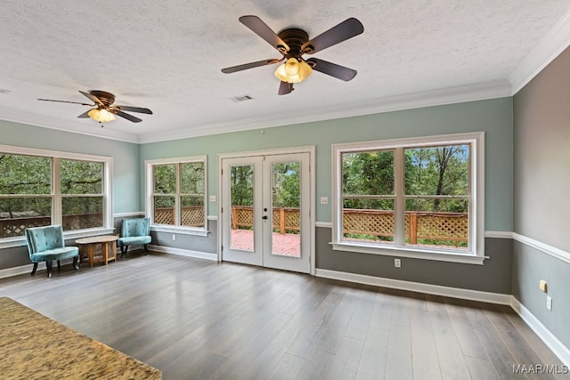 interior space with a healthy amount of sunlight, ceiling fan, and french doors