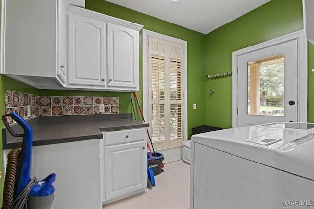 clothes washing area featuring washer / dryer and cabinets