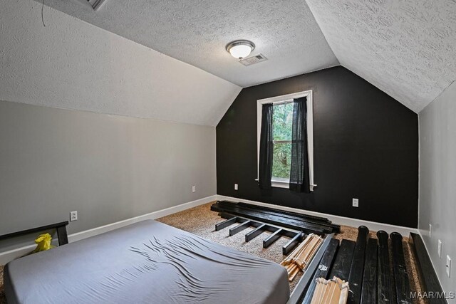 bonus room with a textured ceiling, lofted ceiling, and carpet