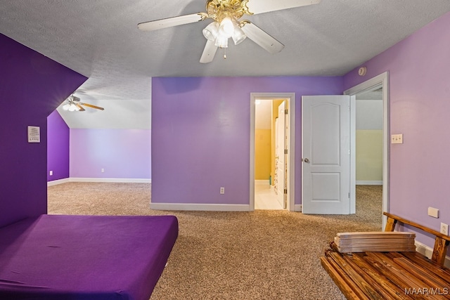 interior space featuring ceiling fan, carpet flooring, and a textured ceiling