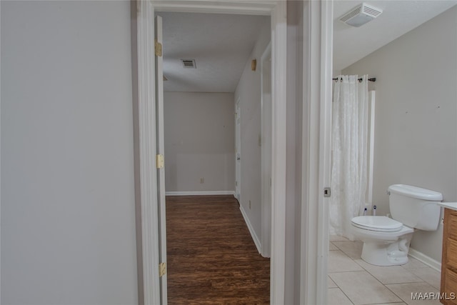 bathroom featuring vanity, toilet, and wood-type flooring