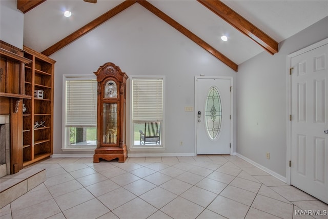 entryway featuring beam ceiling, high vaulted ceiling, and light tile patterned floors