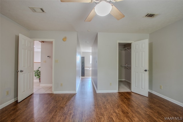 interior space with ceiling fan, a textured ceiling, and dark hardwood / wood-style flooring