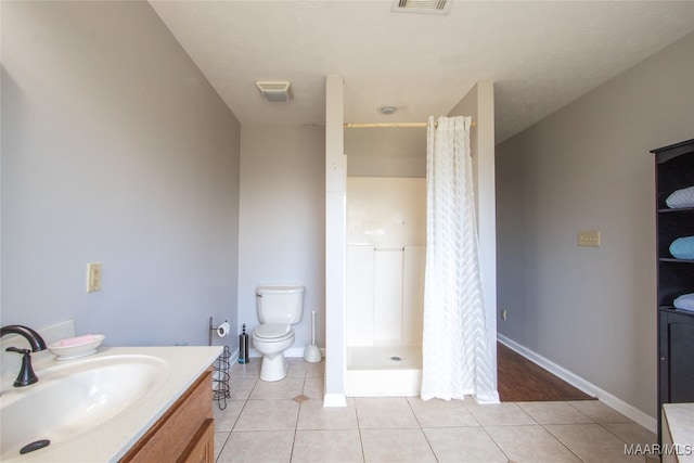 bathroom with vanity, a shower with curtain, toilet, and tile patterned flooring