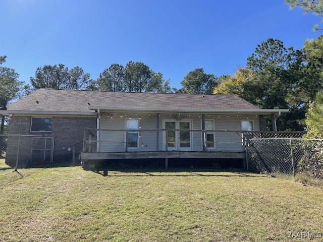 rear view of house with a yard and a deck