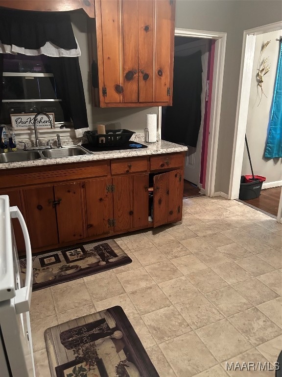 kitchen featuring white range and sink