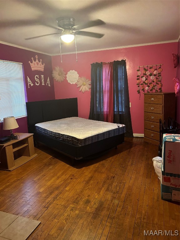 bedroom featuring ornamental molding, ceiling fan, and hardwood / wood-style floors