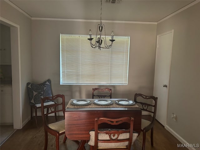 dining room with a notable chandelier, dark wood-type flooring, and crown molding