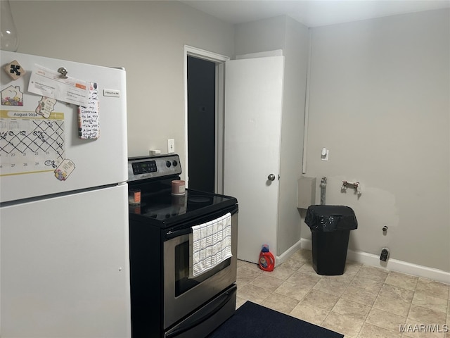 kitchen featuring electric stove and white fridge