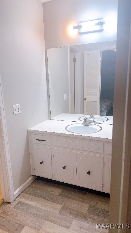 bathroom featuring vanity and wood-type flooring