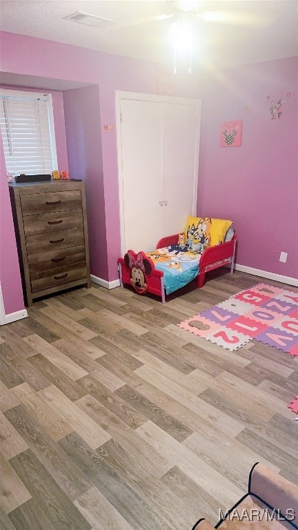 bedroom with wood-type flooring