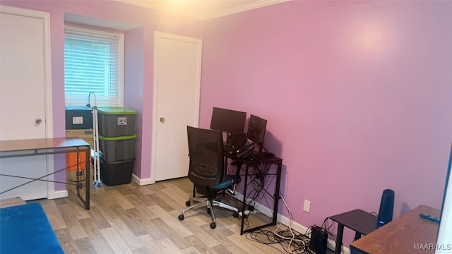 home office featuring crown molding and light hardwood / wood-style floors