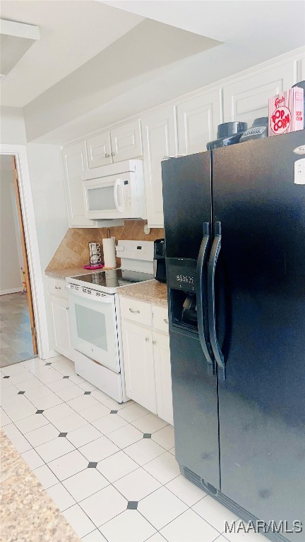 kitchen featuring white appliances, backsplash, and white cabinets