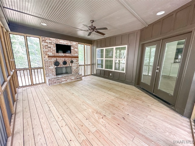 unfurnished living room featuring light hardwood / wood-style floors, a fireplace, ceiling fan, and wooden ceiling