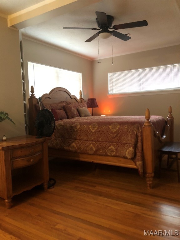 bedroom with crown molding, ceiling fan, and hardwood / wood-style flooring