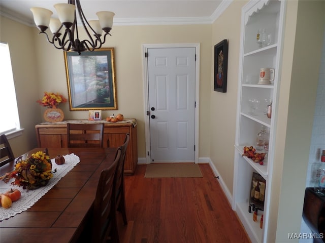 dining room with an inviting chandelier, ornamental molding, and dark hardwood / wood-style flooring