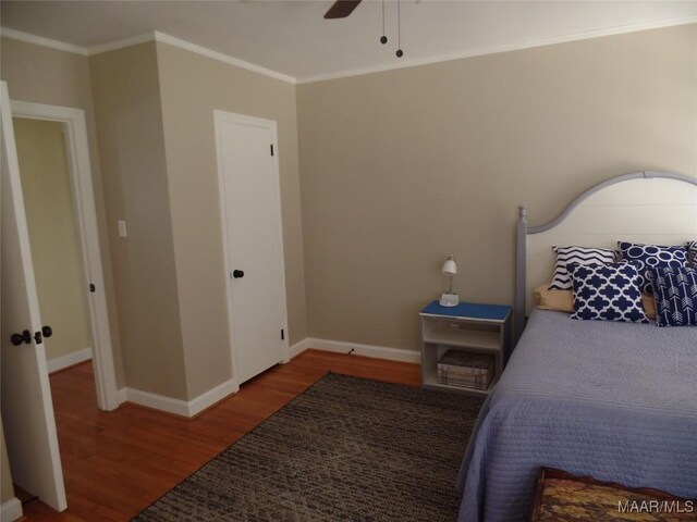 bedroom with wood-type flooring, ornamental molding, and ceiling fan