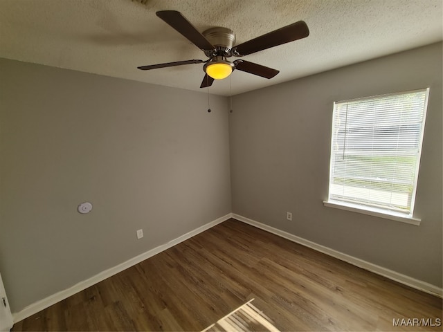 spare room with a textured ceiling, ceiling fan, and hardwood / wood-style flooring