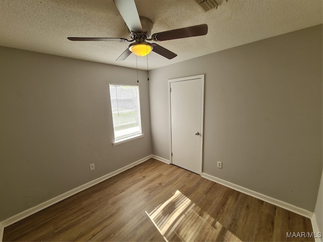 interior space with light hardwood / wood-style flooring, ceiling fan, and a textured ceiling