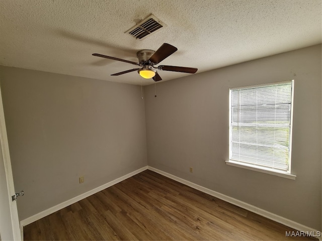 spare room featuring a textured ceiling, hardwood / wood-style floors, and ceiling fan