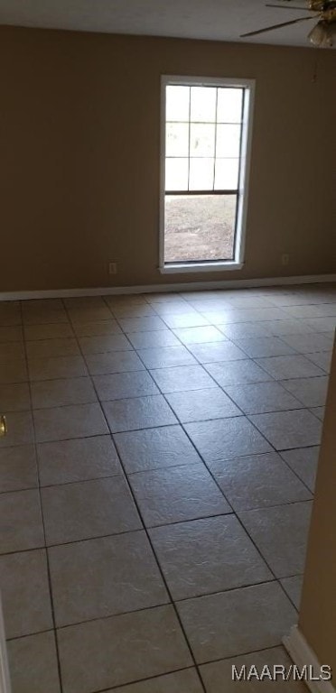 tiled empty room with ceiling fan