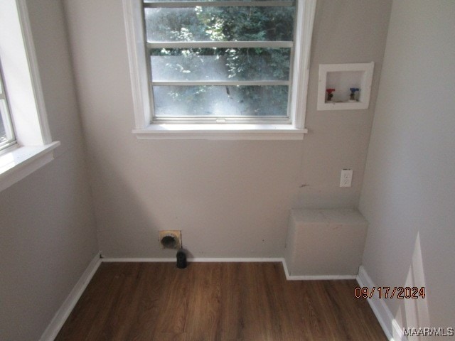 laundry room with dark hardwood / wood-style floors, hookup for a washing machine, and a healthy amount of sunlight