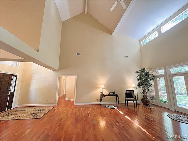 foyer with high vaulted ceiling, wood-type flooring, ceiling fan, and plenty of natural light