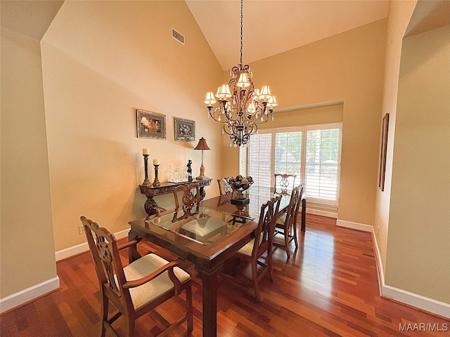 dining room with high vaulted ceiling, a chandelier, and dark hardwood / wood-style floors