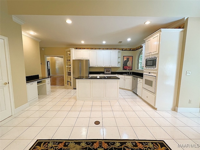 kitchen featuring sink, white cabinets, stainless steel appliances, light tile patterned floors, and crown molding