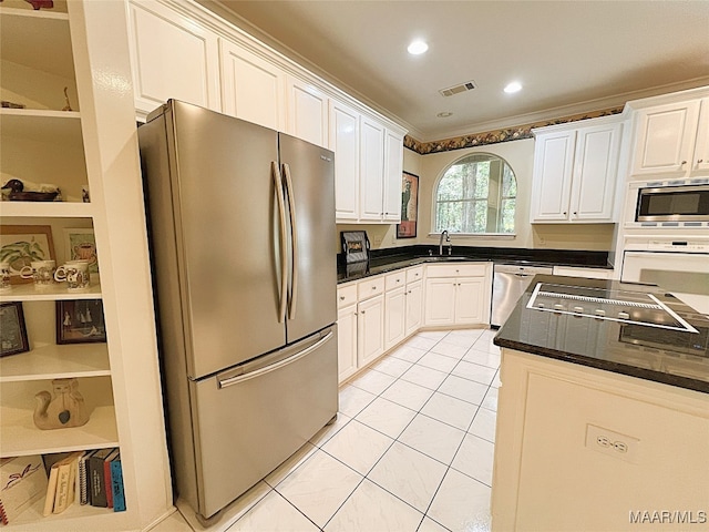 kitchen featuring stainless steel appliances, white cabinets, light tile patterned floors, and sink