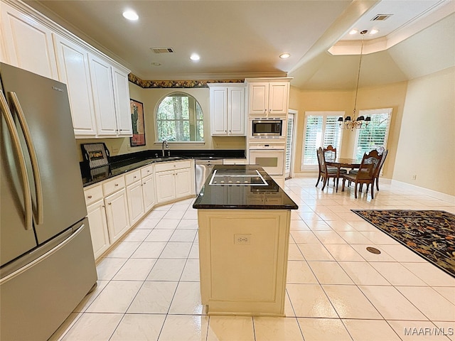 kitchen with stainless steel appliances, white cabinetry, and a healthy amount of sunlight