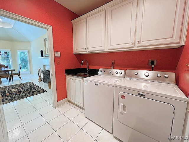 laundry room featuring cabinets, independent washer and dryer, light tile patterned floors, and sink