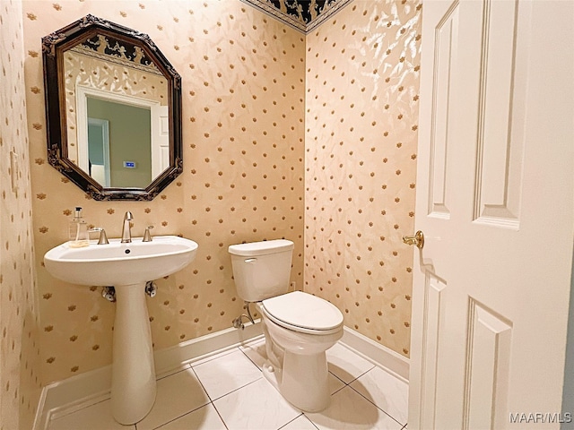 bathroom featuring tile patterned flooring and toilet