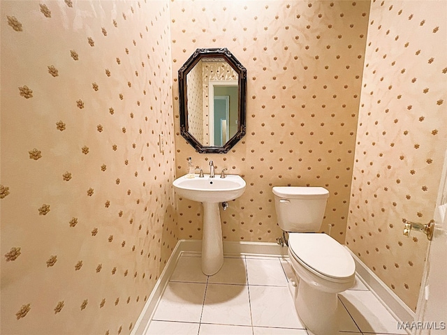 bathroom with toilet and tile patterned floors