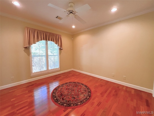 spare room featuring ceiling fan, hardwood / wood-style flooring, and ornamental molding