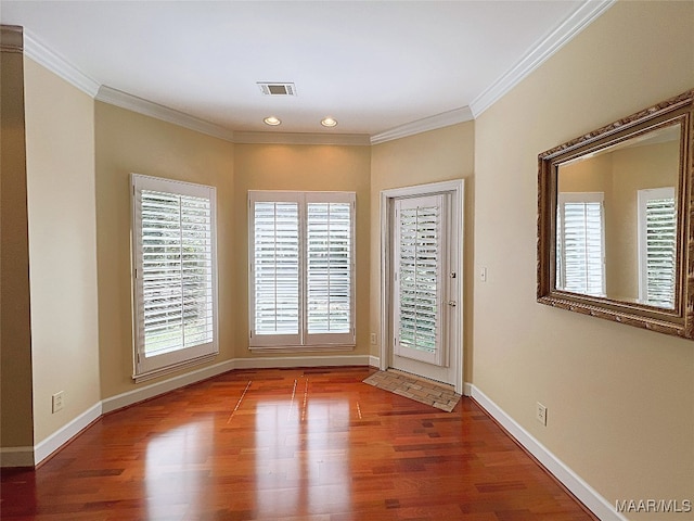 unfurnished room with crown molding and hardwood / wood-style floors