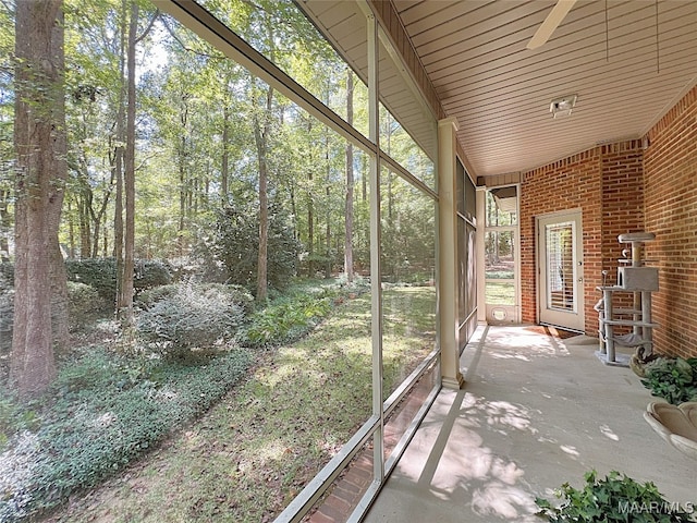 unfurnished sunroom featuring ceiling fan